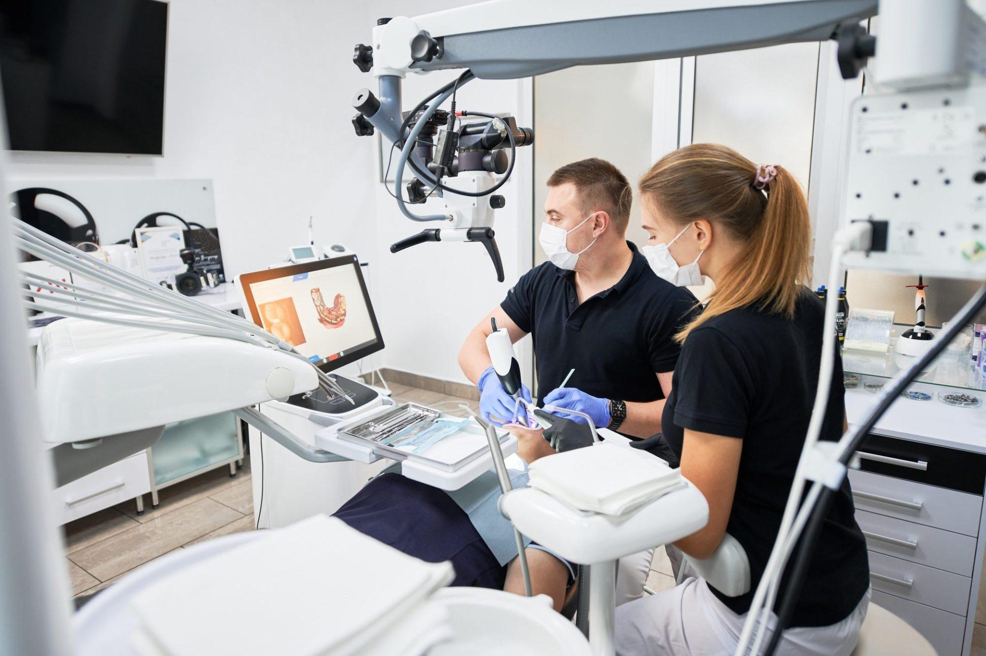 dentist scanning patient s teeth with modern machine for intraoral scanning dentist scanning patient s teeth with modern machine for intraoral scanning