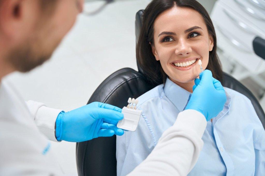 high qualified dental technician choosing proper size and color of dental crown