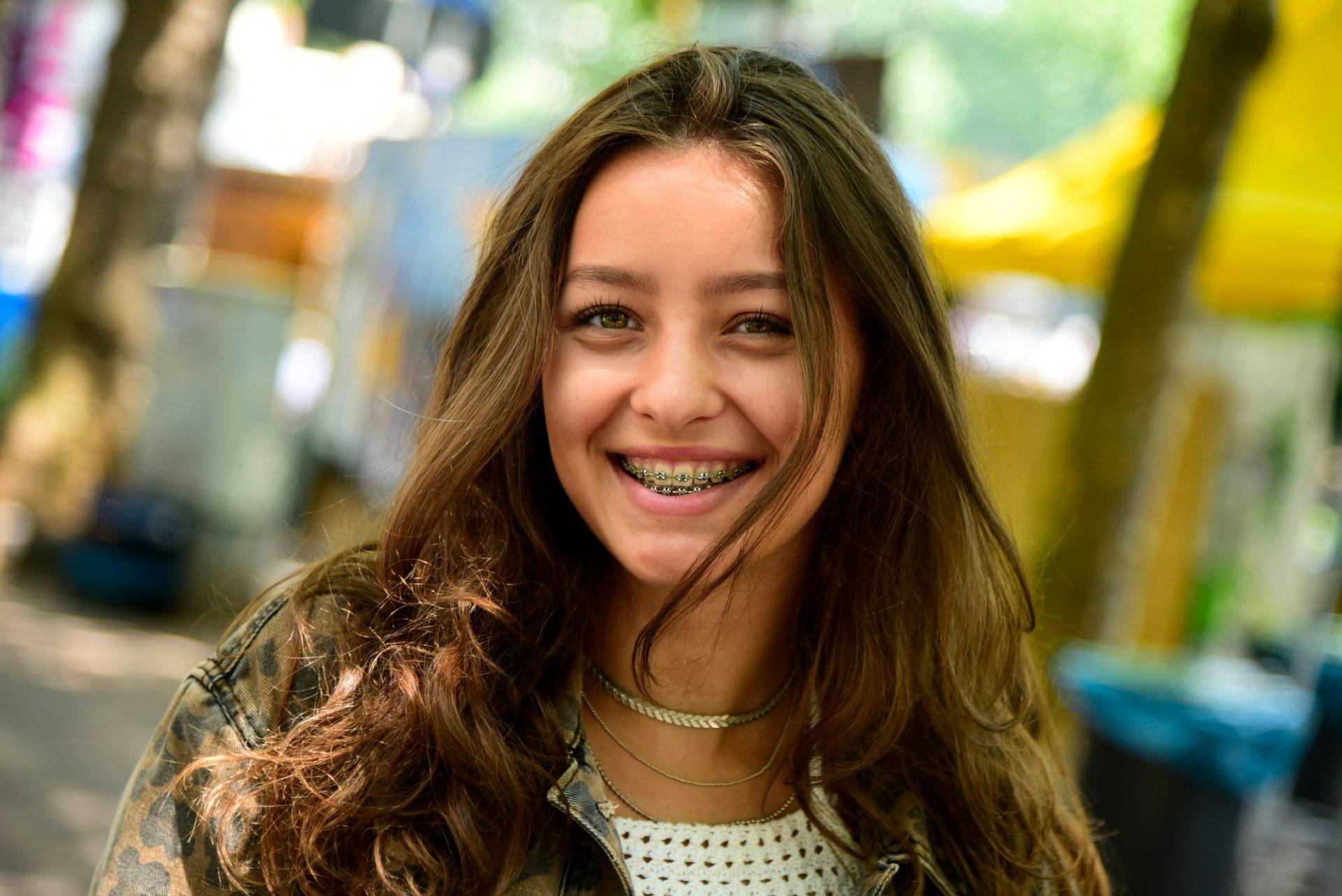 portrait of laughing teenage girl wearing braces portrait of laughing teenage girl wearing braces