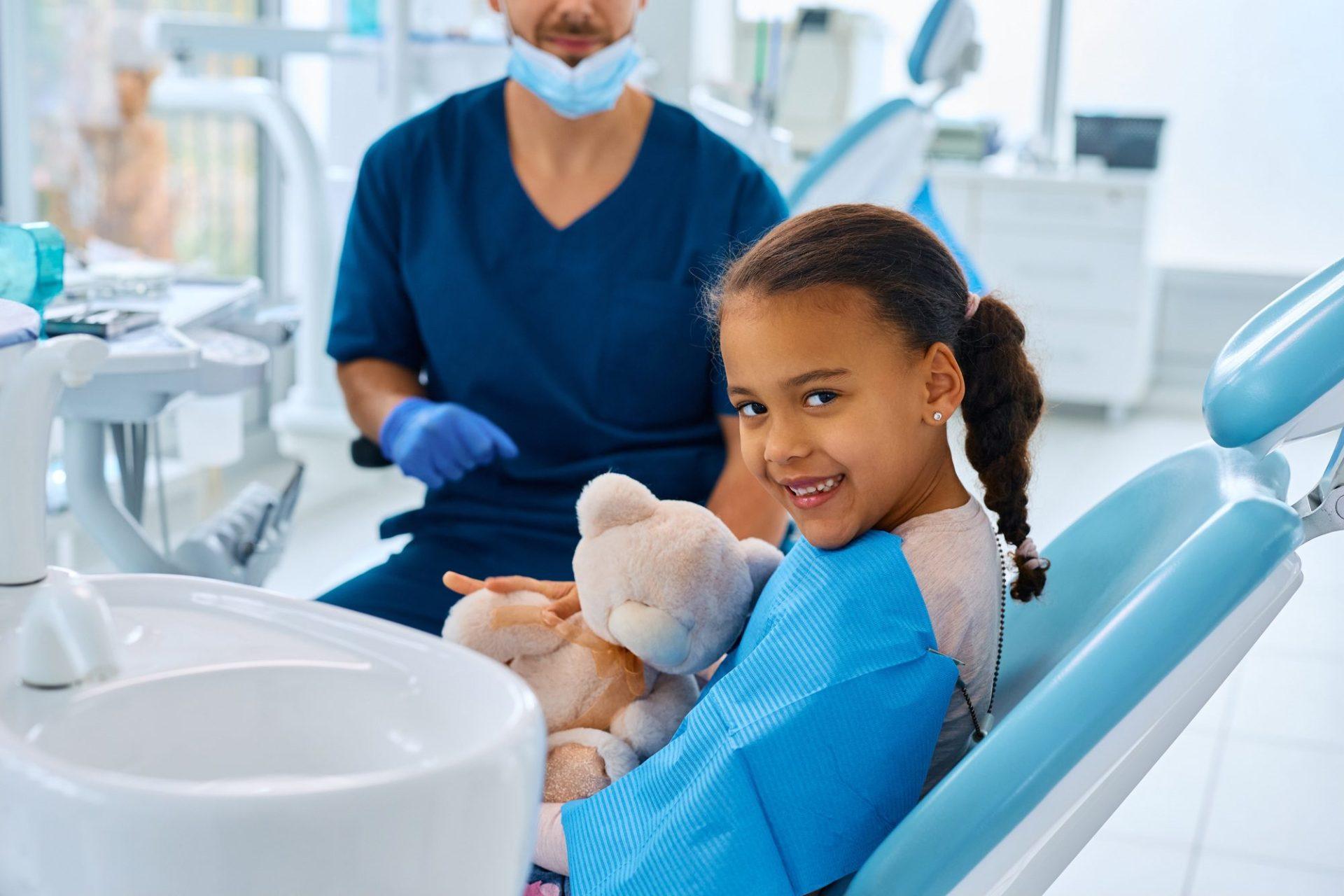 happy black little girl at dentist s office looking at camera happy black little girl at dentist s office looking at camera
