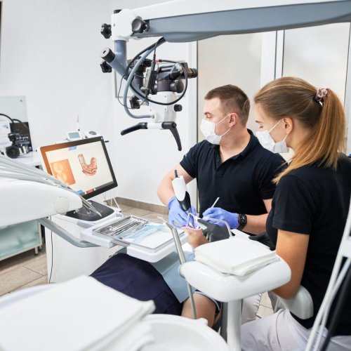 dentist scanning patient s teeth with modern machine for intraoral scanning